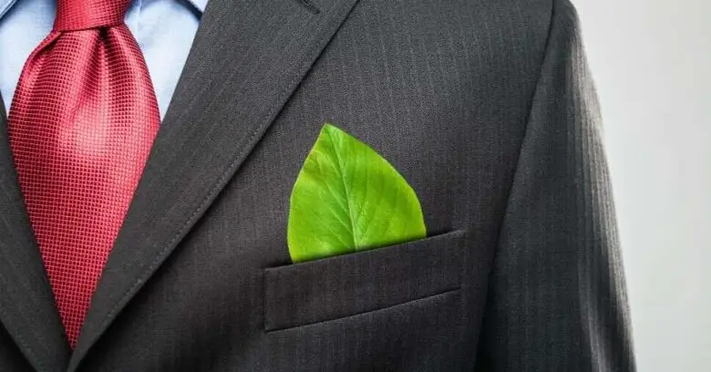 Folha verde no bolso de terno ilustra a prática de o que é greenwashing.